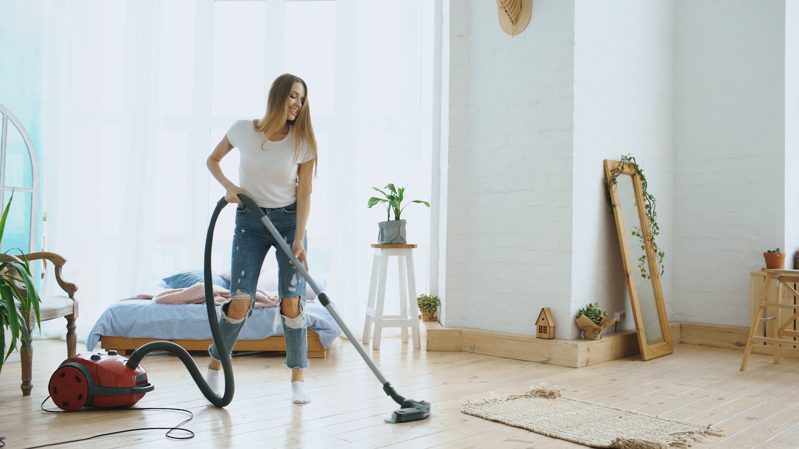 Bright living room being vacuumed
