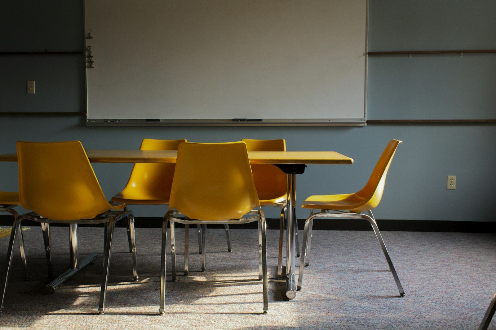 Clean, empty classroom with desks and whiteboard